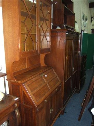 Appraisal: A Cotswold School oak bureau bookcase the upper half fitted