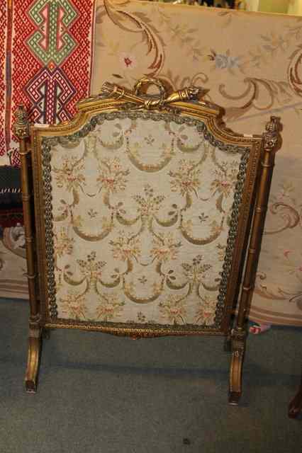 Appraisal: A CONTINENTAL GILT FIRE SCREEN with column supports stylised cornice