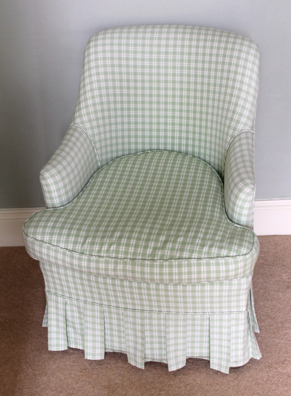 Appraisal: An upholstered tub chair in green Gingham material