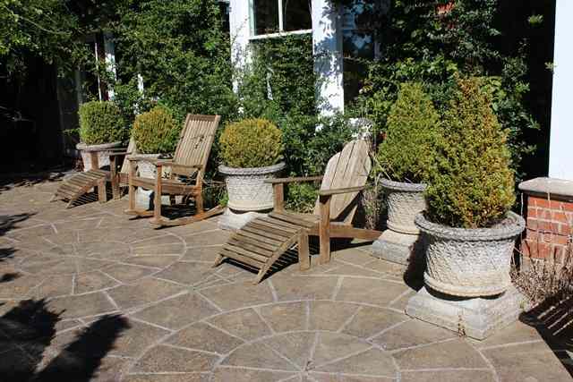 Appraisal: A SET OF FOUR HADDONSTONE CYLINDRICAL PLANTERS with waisted sides