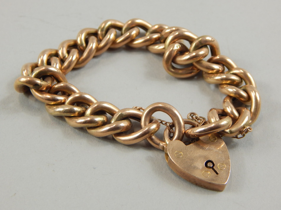 Appraisal: A gate bracelet with heavy curb links and padlock yellow