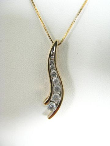 Appraisal: K yellow gold freeform pendant with graduated channel mounted diamonds