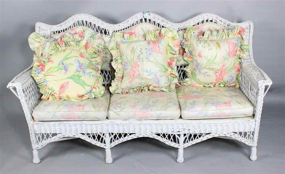 Appraisal: VINTAGE WHITE WICKER SOFA triple arched back with stationary tufted