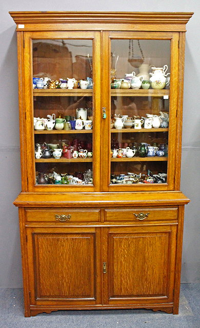 Appraisal: AN EDWARDIAN OAK LIBRARY BOOKCASE glazed doors to the upper