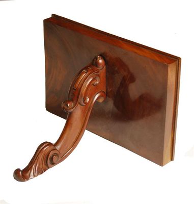 Appraisal: A Victorian mahogany wall bracket with a carved scroll support