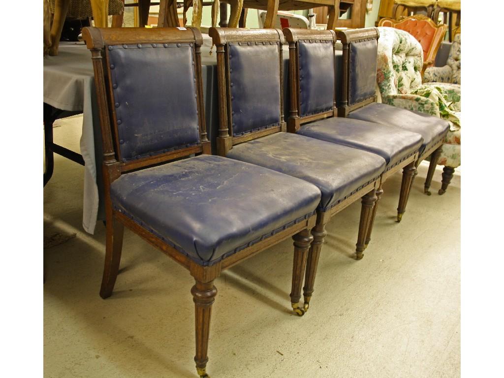 Appraisal: Set of four Edwardian oak dining chairs the stuff-over back