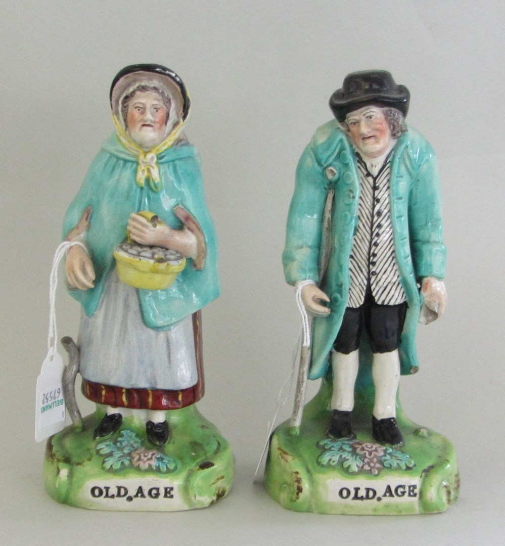 Appraisal: A pair of Staffordshire pearlware figures 'Old Age' each depicting