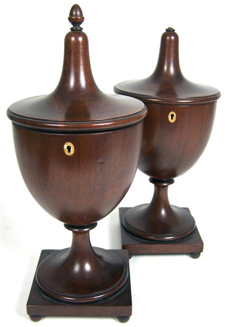 Appraisal: A pair of Regency style mahogany urn tea caddies raised