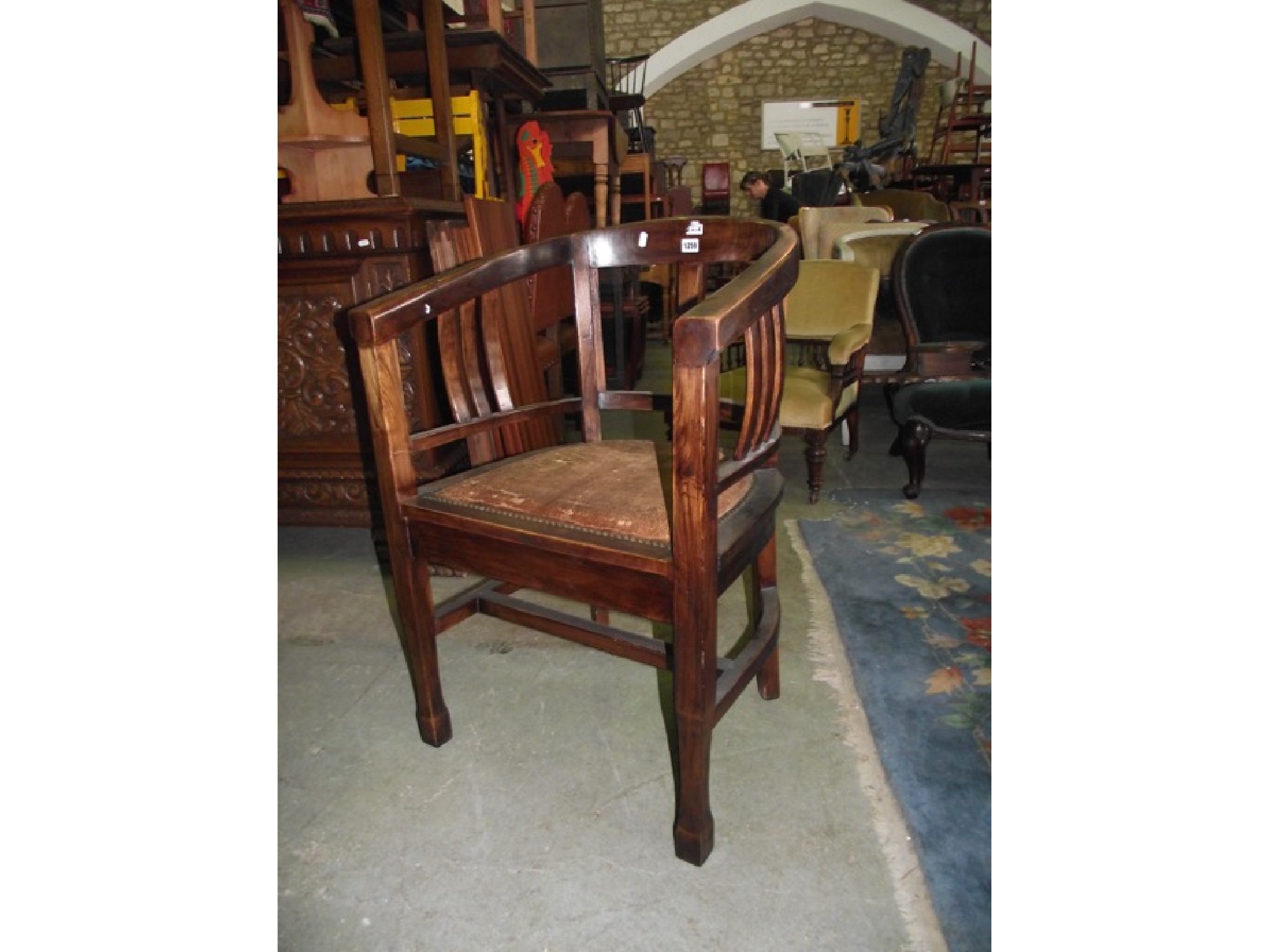 Appraisal: An Art Deco mahogany office chair with horseshoe shaped back