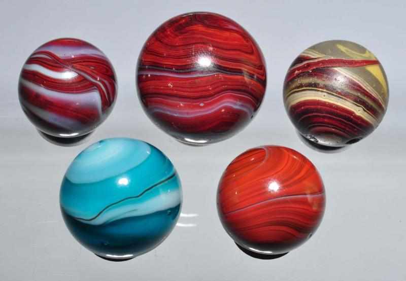 Appraisal: Lot of Oxblood Marbles Description Group includes three M F