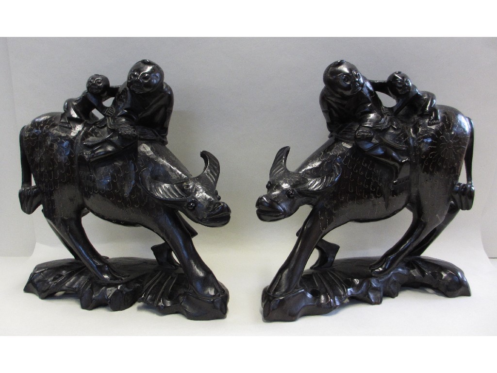 Appraisal: Pair of carved wooden groups of water buffalos and figures