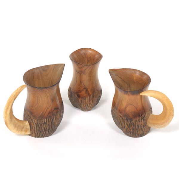 Appraisal: A FERNANDEZ CARVED OLIVE WOOD AND RAM'S HORN DRINKING SET