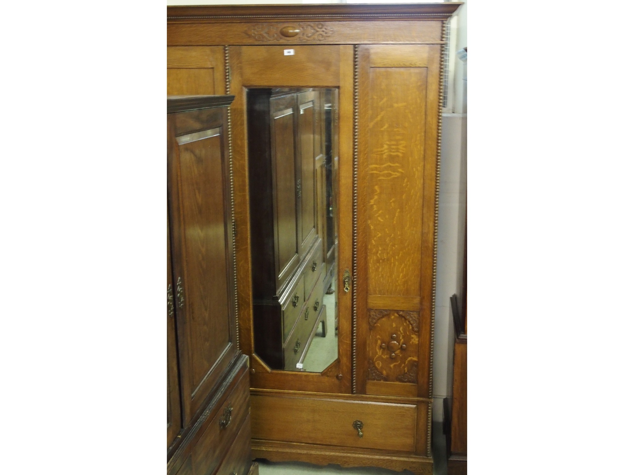 Appraisal: An oak mirrored single door wardrobe with drawer to base