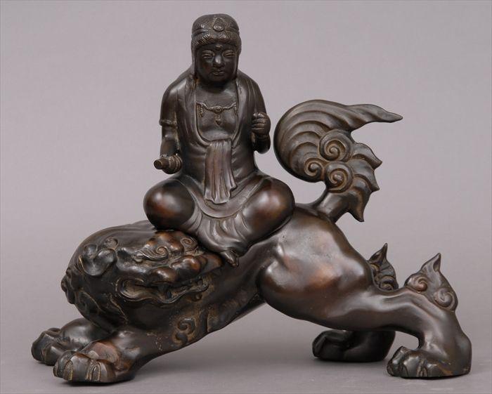 Appraisal: JAPANESE BRONZE TWO-PIECE RIDER ON SHI SHI DOG The figure