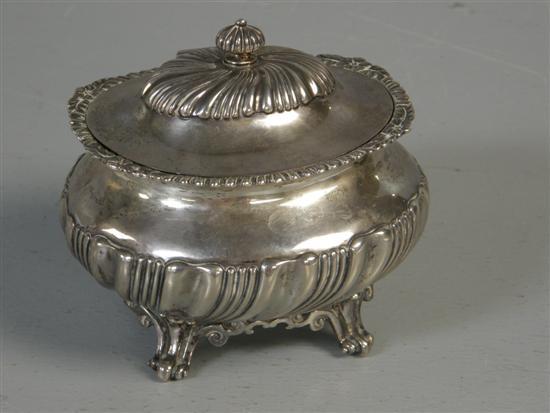 Appraisal: George V silver oval tea caddy with half reeded body