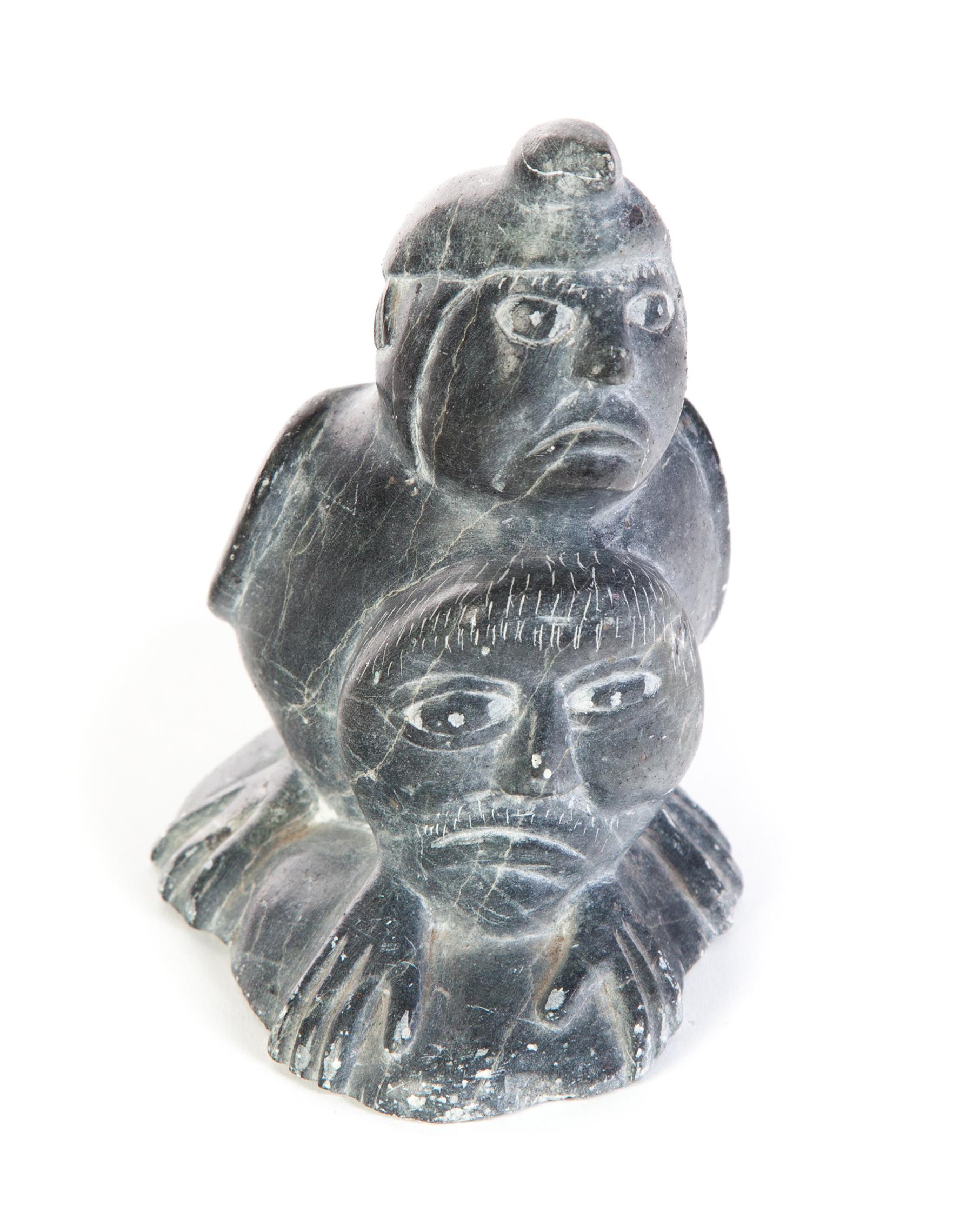 Appraisal: INUIT CARVING OF SHAMAN Twentieth century hardstone Human faces with