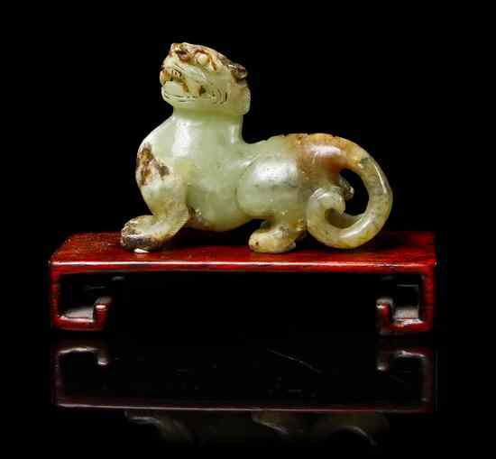 Appraisal: A Yellow Jade Model of a Beast having russet and