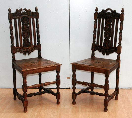 Appraisal: A pair of oak hall chairs carved in the Baroque