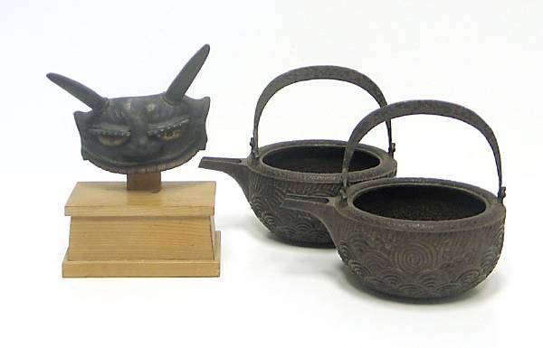 Appraisal: A group of three Japanese metal decorations Including a helmet