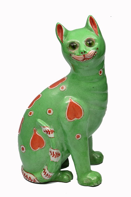 Appraisal: A PORCELAIN GREEN GLAZED GALLE STYLE CAT decorated with red