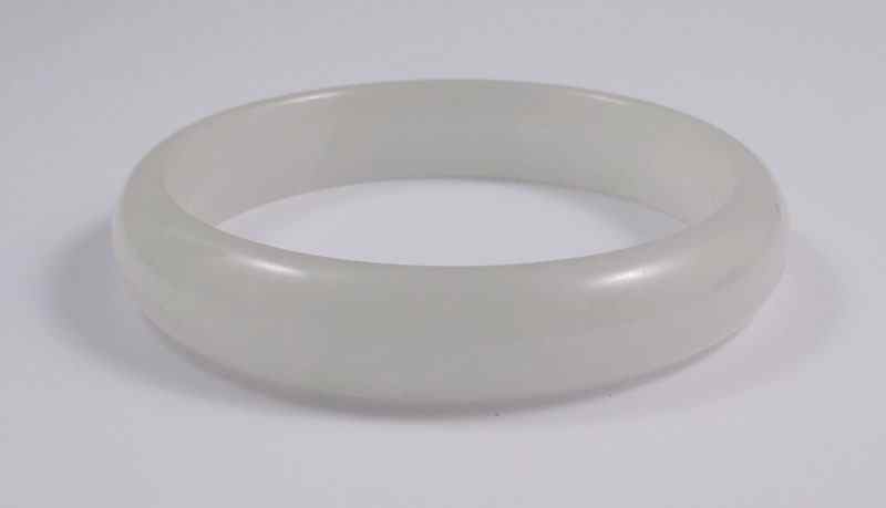 Appraisal: LIGHT GREEN JADEITE JADE BANGLE BRACELET '' interior diameter