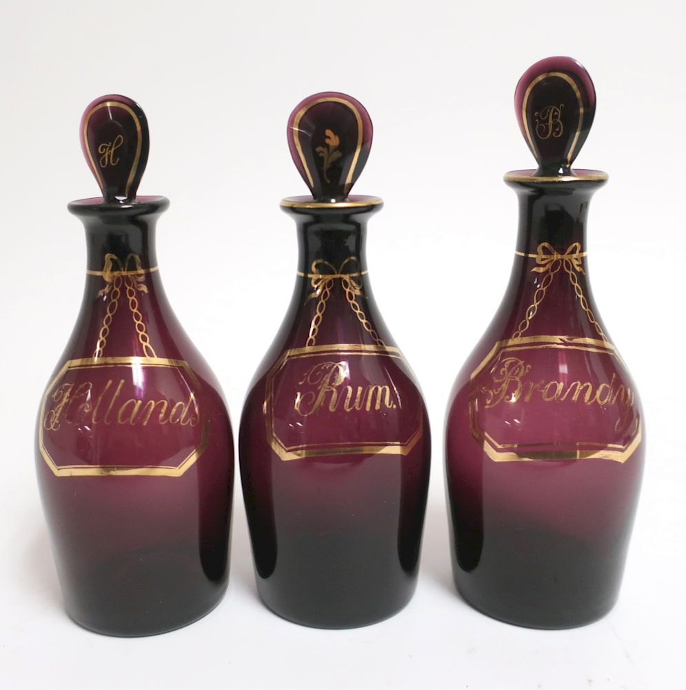 Appraisal: Ruby Glass Liquor Decanters Lettered in gilt Brandy rum hollands