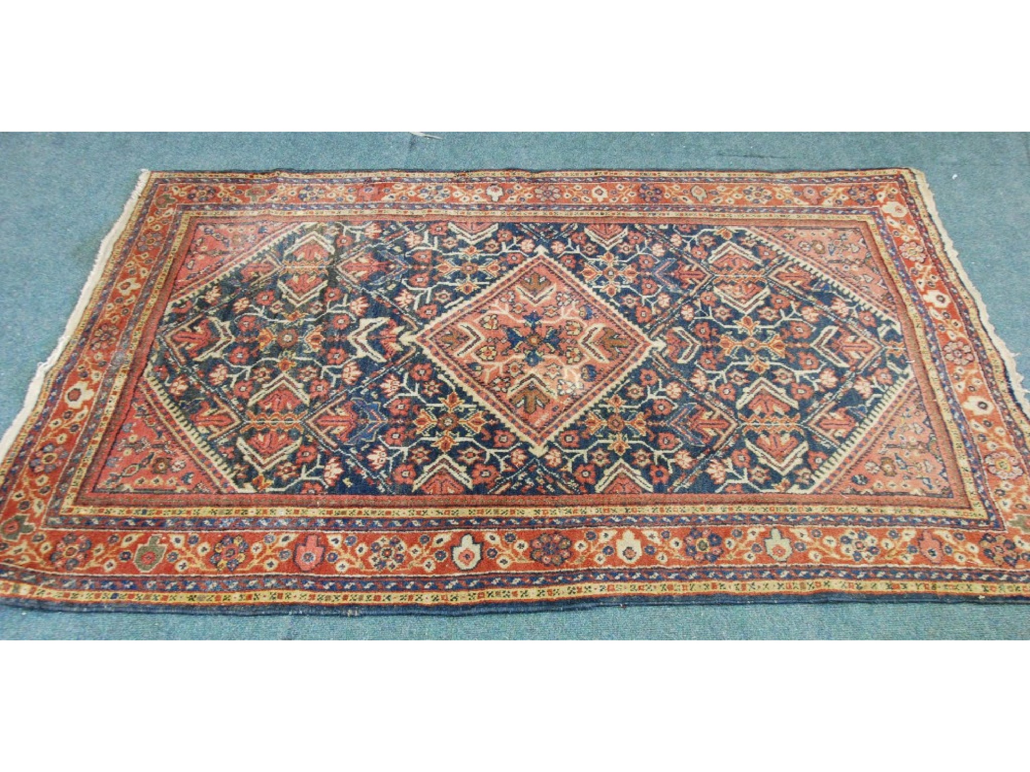 Appraisal: EASTERN RUG crimson diamond shaped medallion on a midnight blue