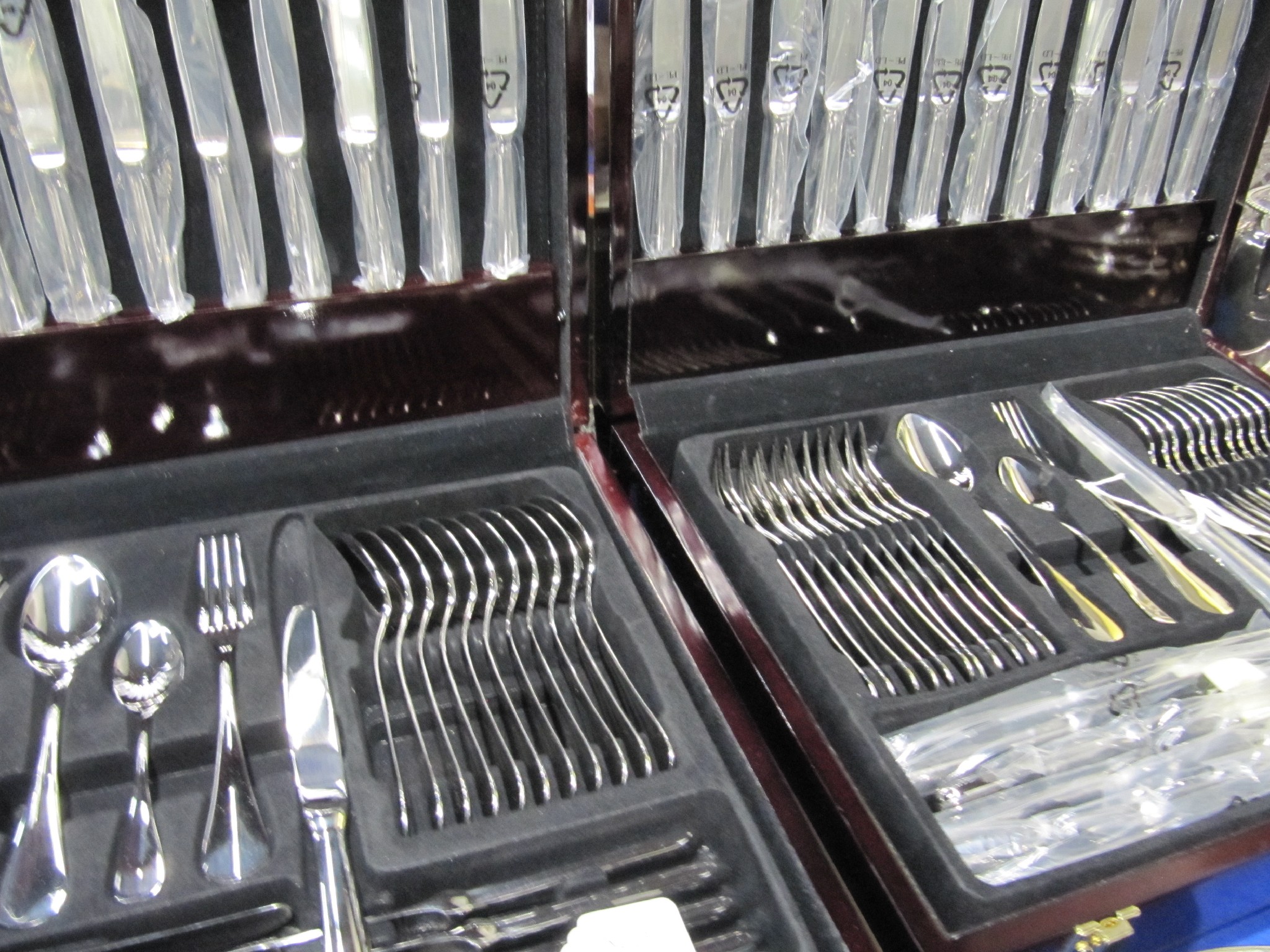 Appraisal: A lot comprising two modern canteens of stainless steel cutlery