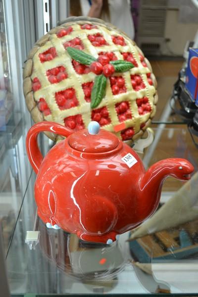 Appraisal: A RETRO DINOSAUR TEAPOT AND A CHERRY PIE WALLHANGING