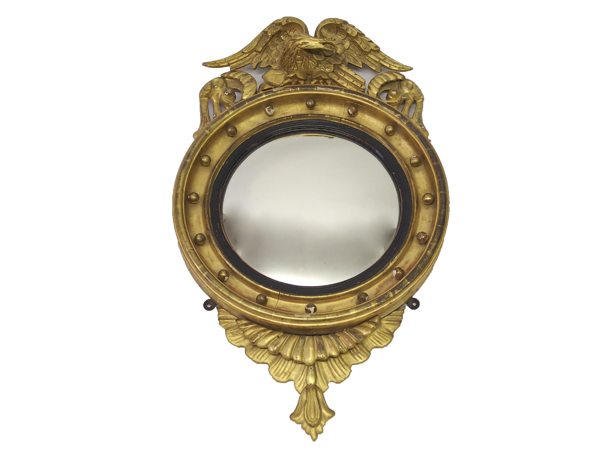 Appraisal: A Regency style giltwood convex mirrorwith eagle surmount and moulded