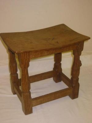 Appraisal: AN ADZED OAK STOOL by Robert Mouseman Thompson of dished