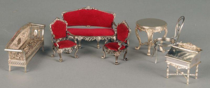 Appraisal: Upholstered Silver Miniature Furniture Two upholstered chairs and a matching