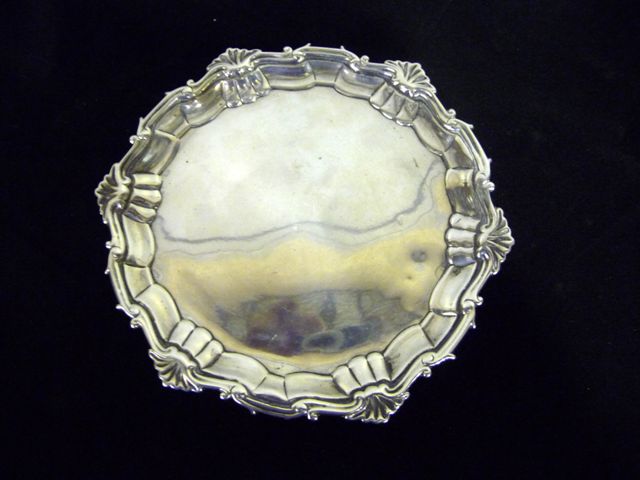 Appraisal: A silver salver with scroll and shell border on three