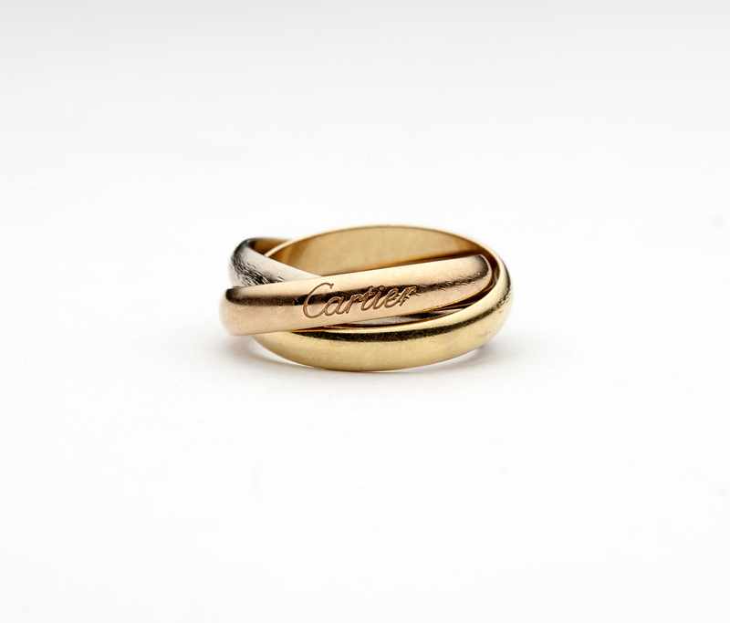 Appraisal: A tricolor gold ''Trinity'' ring by Cartier with box and