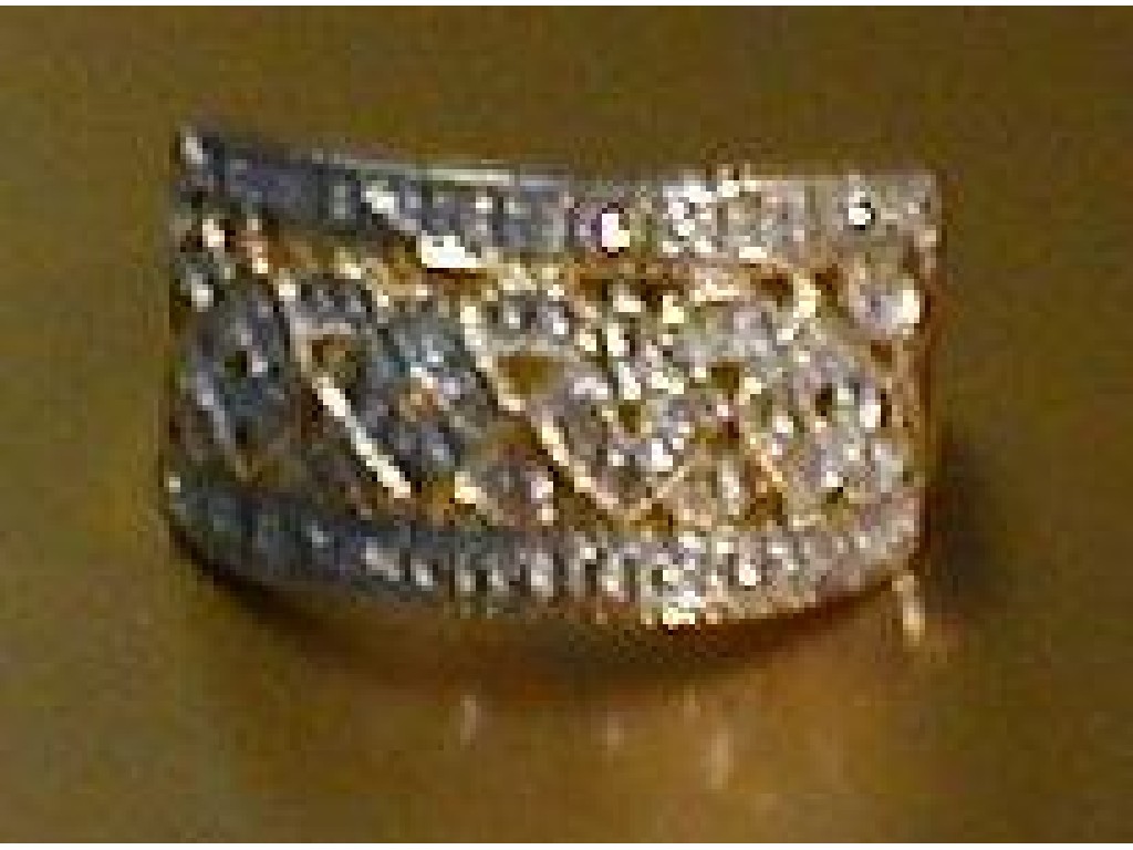 Appraisal: A dress ring a wide pierced band with lozenge motifs