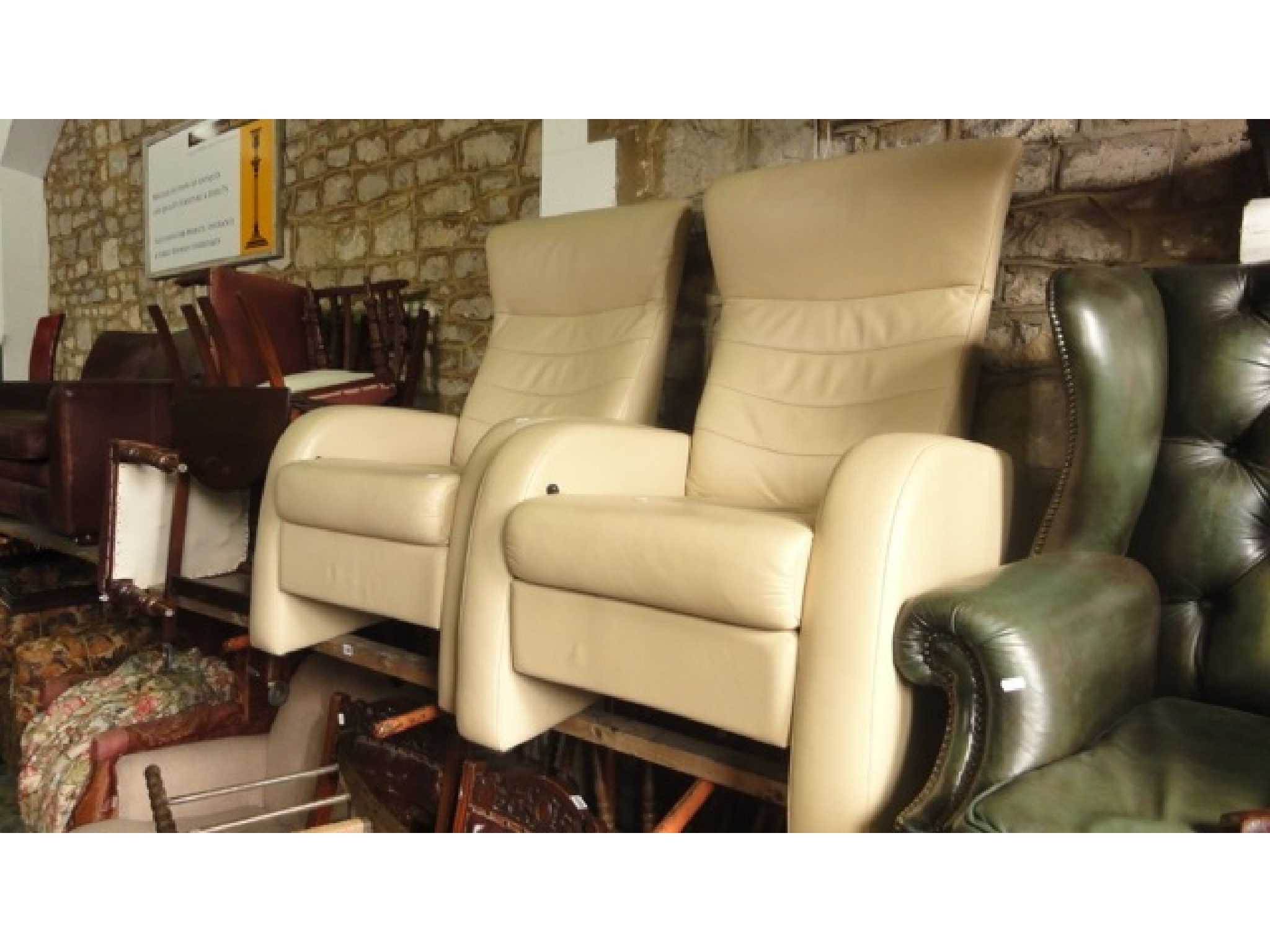 Appraisal: A pair of contemporary cream soft leather upholstered reclining armchairs