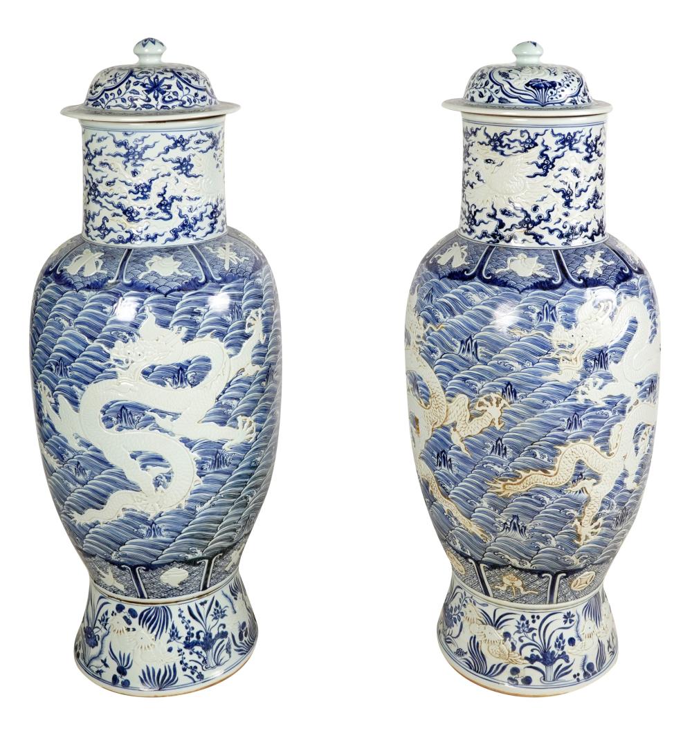 Appraisal: PAIR OF MONUMENTAL CHINESE PORCELAIN URNSeach relief-molded with five-toed dragons