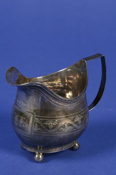 Appraisal: A GEORGE III CREAM JUG of bellied oval form with