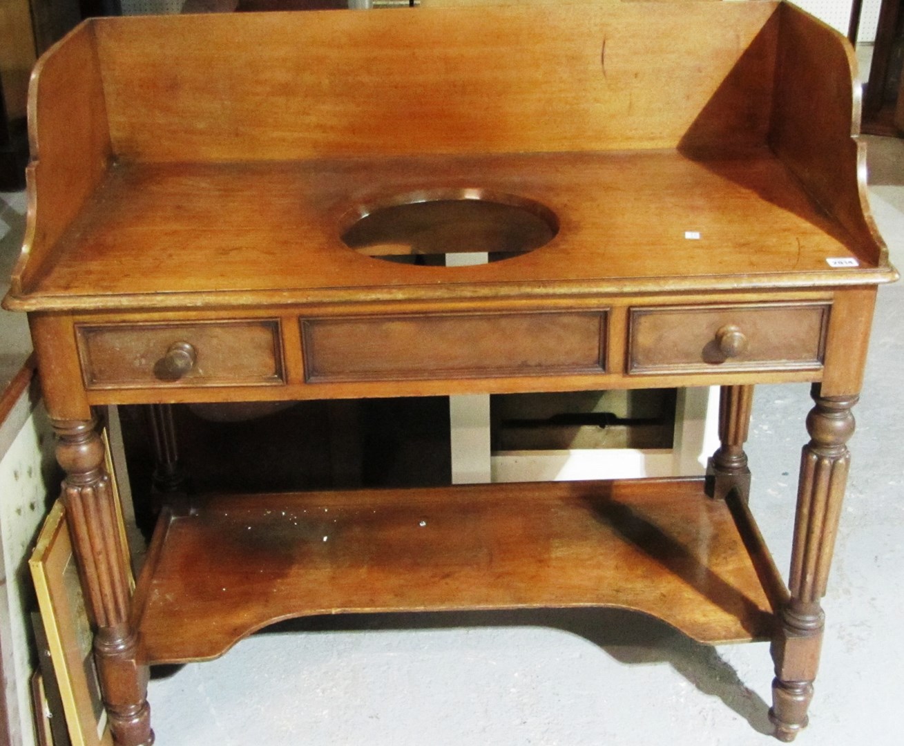 Appraisal: A th century mahogany wash stand with galleried back and