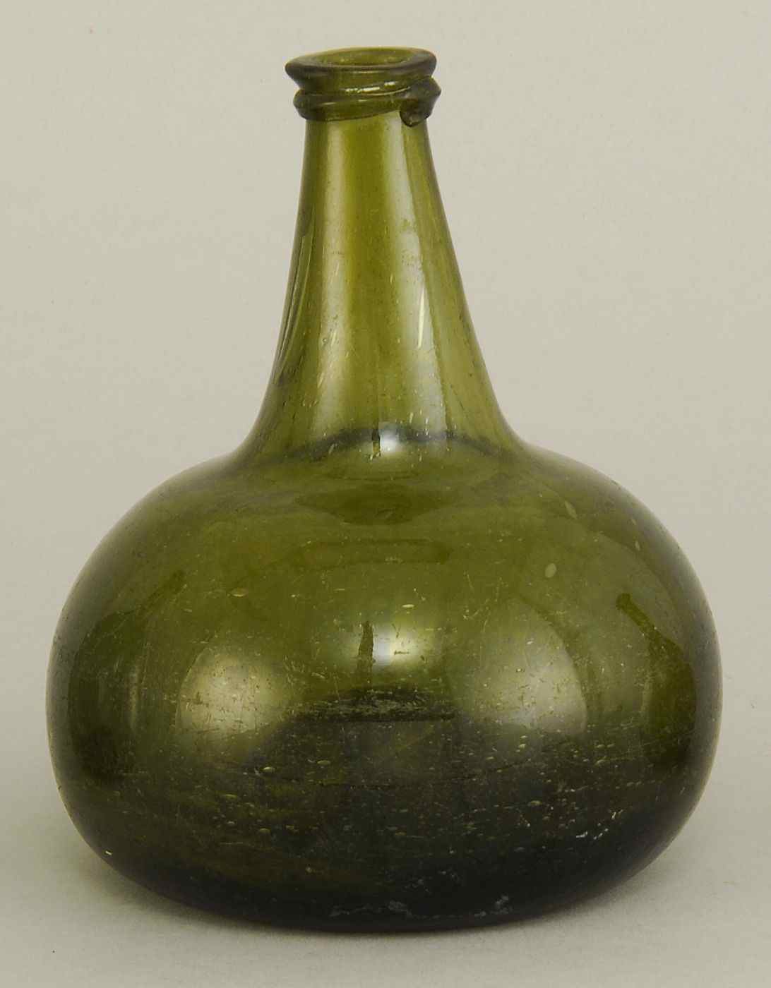 Appraisal: ANTIQUE DARK GREEN BLOWN GLASS BOTTLE th CenturyIn squat form