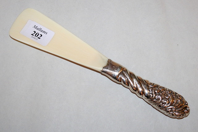 Appraisal: A VICTORIAN SILVER HANDLED IVORY SHOT HORN with scroll and