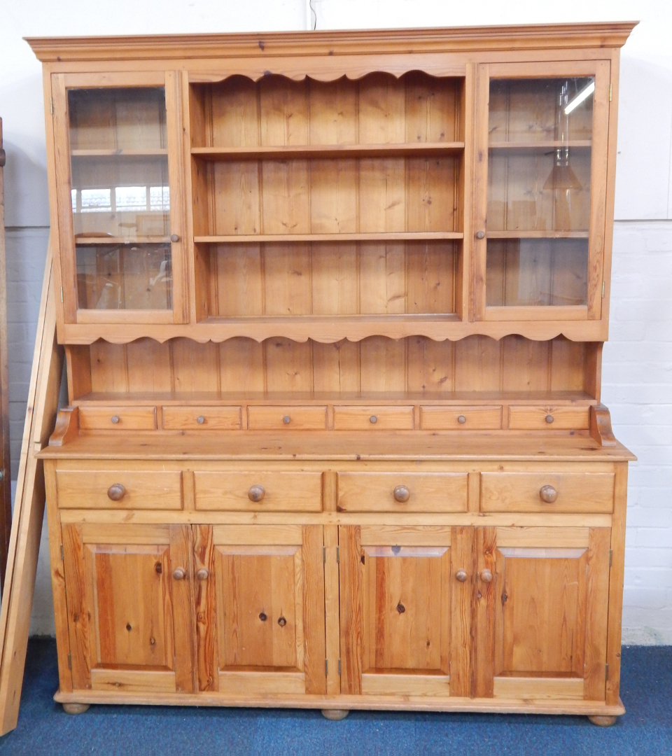 Appraisal: A pine kitchen dresser the out swept pediment over a