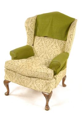 Appraisal: A wing armchair in George II style having walnut carved