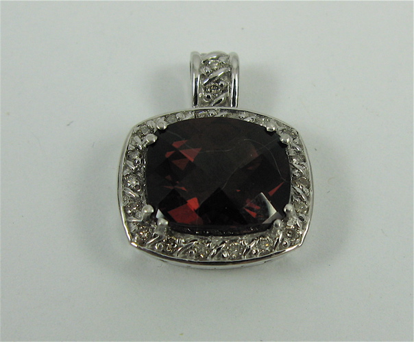 Appraisal: GARNET DIAMOND AND K WHITE GOLD PENDANT set with a