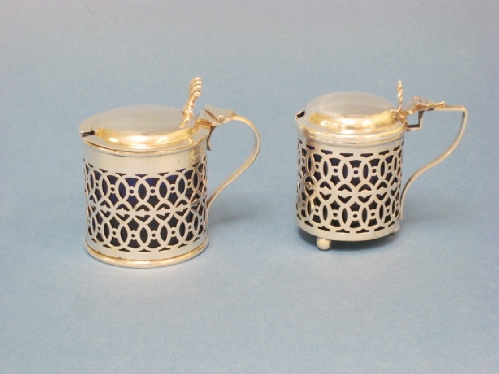 Appraisal: Two pierced circular Mustard Pots with blue glass liners Birmingham