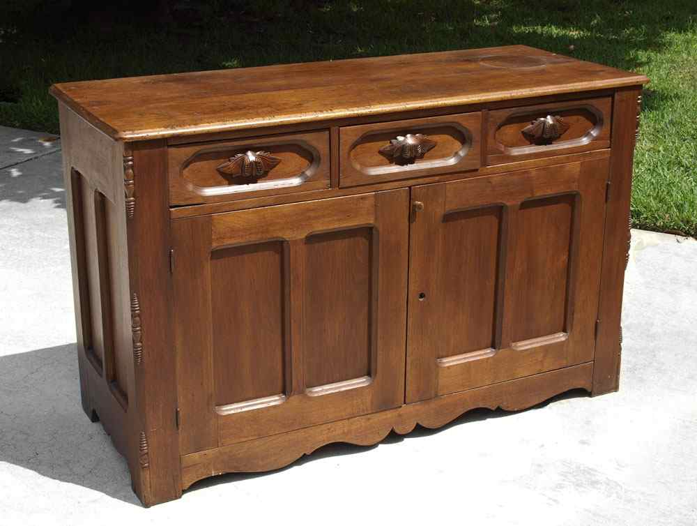 Appraisal: WALNUT VICTORIAN SERVER drawers with carved wood handles over doors