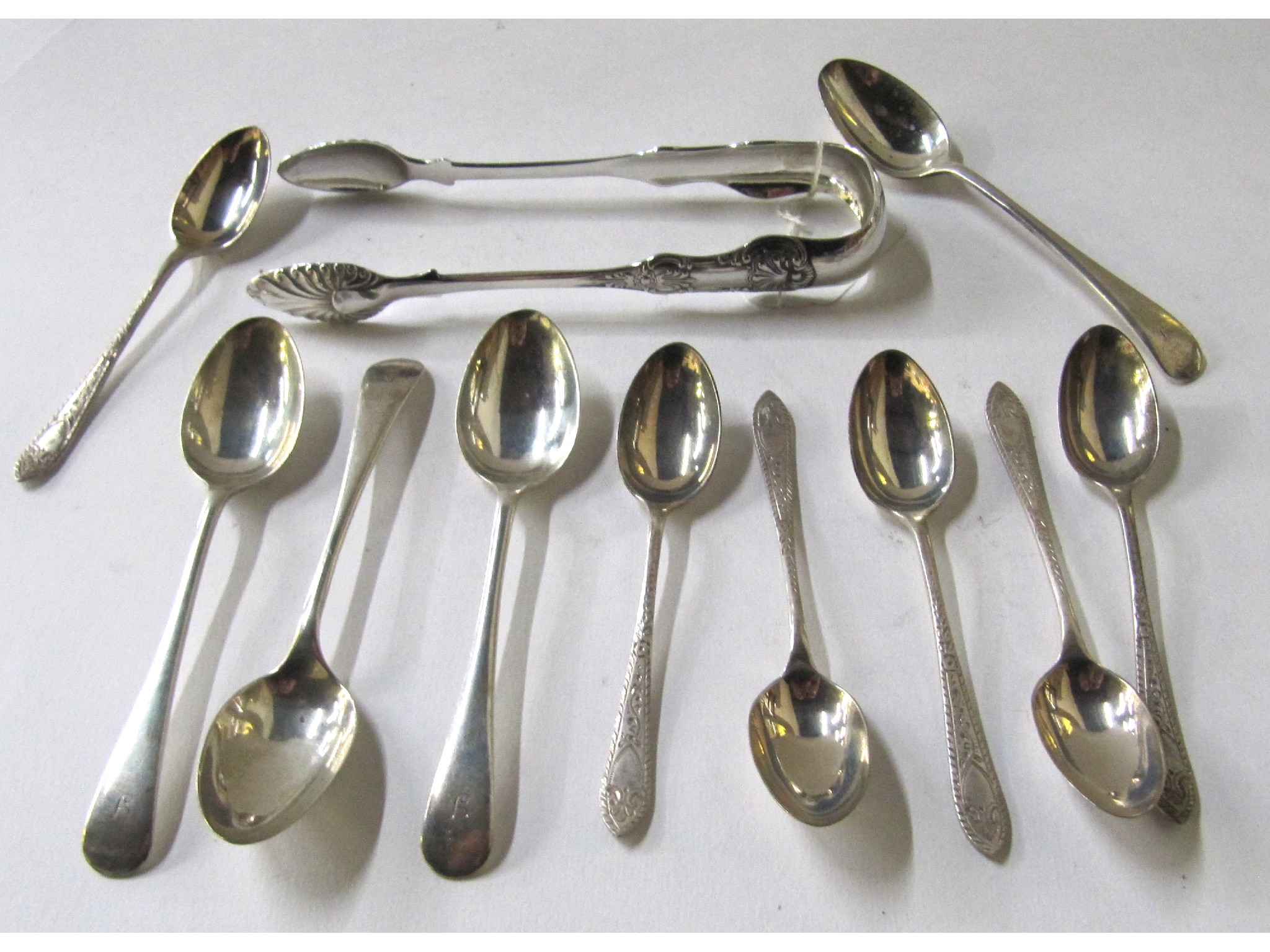 Appraisal: A lot comprising two sets of six silver spoons and