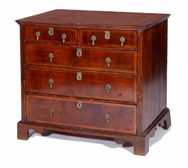 Appraisal: A WALNUT CHEST the quarter veneered and wide crossbanded top