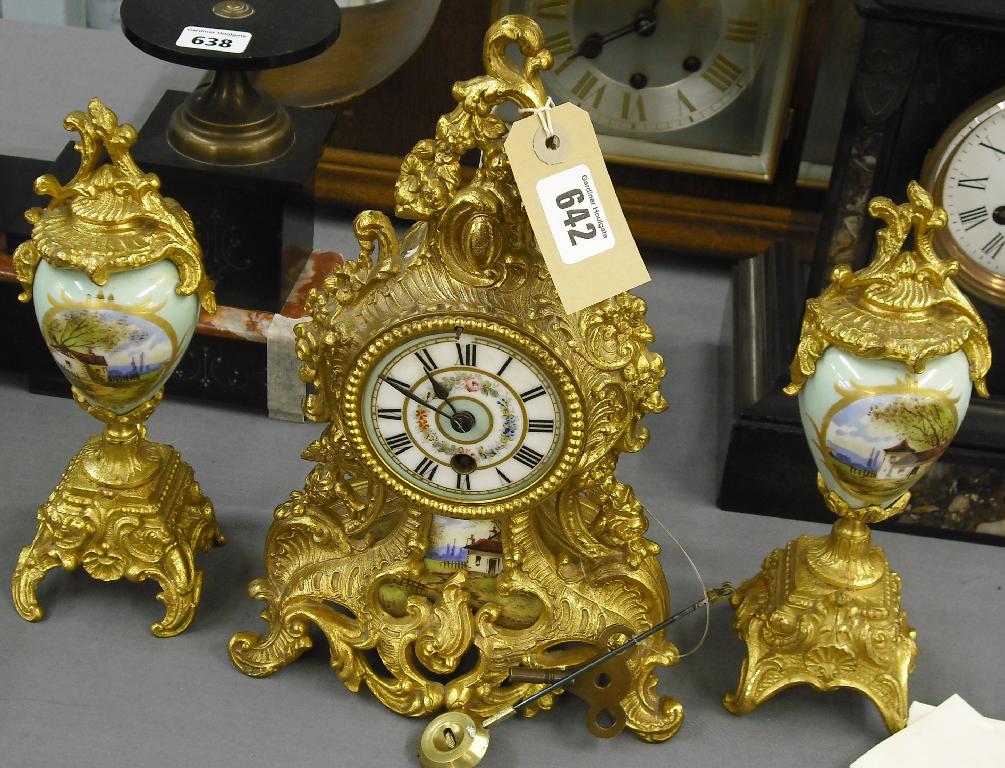 Appraisal: Decorative French gilt spelter and porcelain mantel clock garniture the