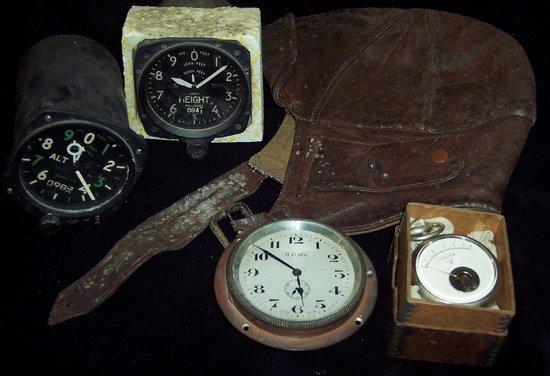 Appraisal: A leather flying hat two altimeters and a clock